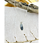 Shazar (dendrite agate) silver pendant displayed against a soft parchment background with rustic driftwood accent.