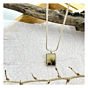 Handmade rectangular Shazar pendant named Forestfall Light, displayed with rustic wood and textured paper for a natural, earthy aesthetic.