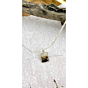 Rectangular Shazar silver pendant titled Forest Dream laid on a soft textured backdrop with rustic wood accents and a delicate silver chain.