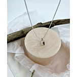 Pendant displayed against soft, wintry textures with driftwood and tissue accents, evoking the serene quiet of a frost-kissed morning.